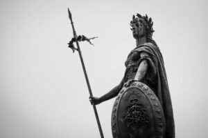 man holding shield statue