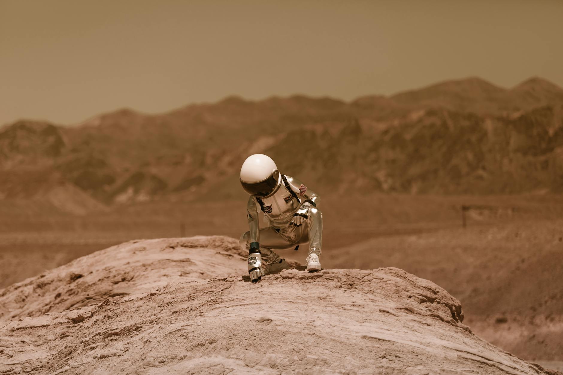 astronaut crouching on the ground